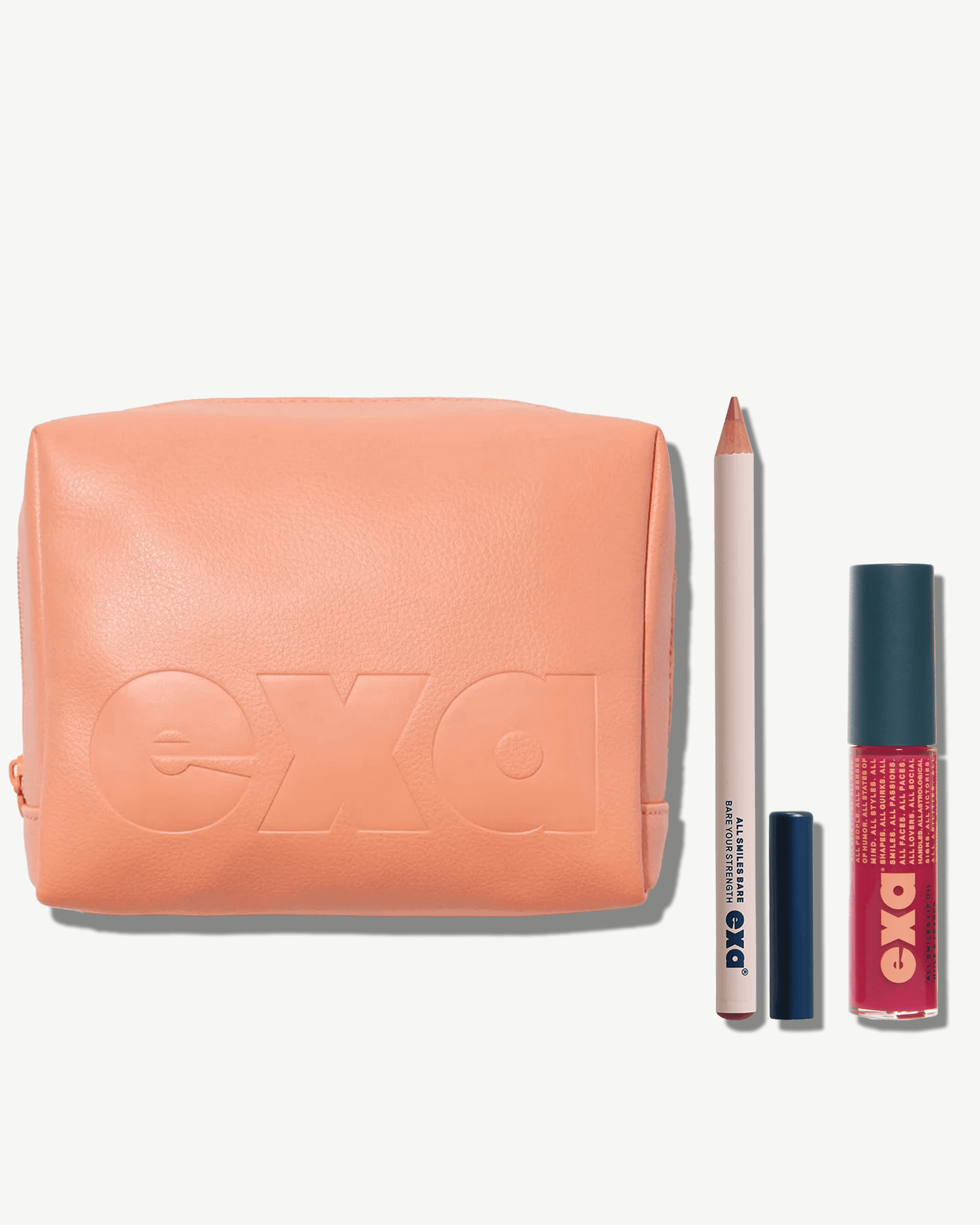 Exa All Smiles Bare Lip Liner in Strength, All Smiles Lip Oil in Lover, and All In Essential Makeup Bag
